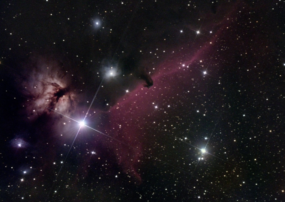 Astrofotografie eines Nebels mit Sternen und einer markanten dunklen Struktur